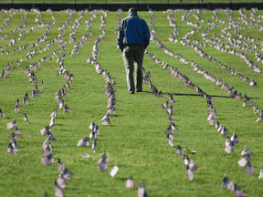 Chris Duncan, whose 75-year-old mother Constance died from COVID-19, walks through a COVID Memorial Project installation of 20,000 American flags, representing the 200,000 U.S. lives lost, on the National Mall in Washington, D.C., September 22, 2020.