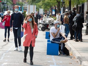 Pedestrians make their way along St. Catherine street in Montreal, Tuesday, Sept. 15, 2020. Montreal as well as three other regions of the province have been upgraded to yellow under Quebec's colour-coded alert system.