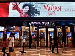 People buy tickets for Disneys Mulan film at a cinema inside a shopping mall in Bangkok on September 8, 2020. - Disney's "Mulan" remake is facing fresh boycott calls after it emerged some of the blockbuster was filmed in China's Xinjiang, where widespread rights abuses against the region's Muslim population have been widely documented.