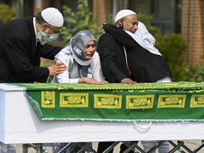 Daughter Bebe Zafis, second left, and family members react at her fathers casket during the funeral of Mohamed-Aslim Zafis in Toronto on Wednesday, September 16, 2020. Police say Zafis was fatally stabbed by an unknown suspect while he sat outside the mosque as he controlled entry to the building in order to comply with public health protocols.