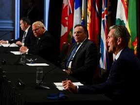 Manitoba Premier Brian Pallister, right, speaks as Quebec Premier Francois Legault, Ontario Premier Doug Ford, and Alberta Premier Jason Kenney look on during a press conference in Ottawa on Friday, Sept. 18, 2020.
