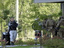 RCMP officers prepare to enter an apartment complex in connection with the mailing of ricin to President Trump Monday, September 21, 2020 in St. Hubert, Quebec.