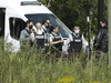 RCMP officers gather outside an apartment complex during a raid in connection with the mailing of ricin to President Trump, Monday, September 21, 2020 in St-Hubert, Quebec.