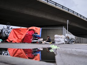 A homeless camp is shown under an overpass in Calgary, Alta., Wednesday, May 20, 2020, amid the worldwide COVID-19 pandemic. A doctor is worried Alberta's homeless shelters won't have enough space to keep everyone safe once the cold weather hits.