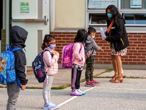 Students arrive for the first time since the start of the coronavirus disease (COVID-19) pandemic at Hunter's Glen Junior Public School, part of the Toronto District School Board (TDSB) in Scarborough, Ontario, Canada September 15, 2020.