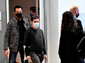 Charlie Hebdo webmaster Simon Fieschi (C), who appeared as a witness, leaves the courthouse at the Paris courthouse in Paris, on September 9, 2020, after a hearing of the trial of 14 suspected accomplices in Charlie Hebdo and Hyper cacher jihadist killings.