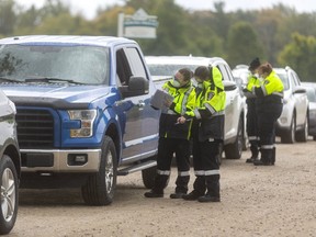 Middlesex-London paramedics interview motorists as they wait to be tested at a COVID-19 testing centre on Hamilton Road at the Dorchester Outdoor Recreation Centre run by the Middlesex-London Paramedic Service. 
The site was soon filled to capacity on Wednesday.
Photograph taken on Wednesday September 30, 2020.