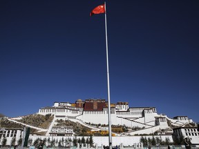 A Chinese flag flutters on a pole in front of the Potala Palace in Lhasa, Tibet Autonomous Region, China November 17, 2015.