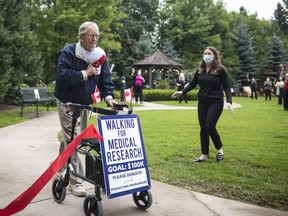 George Markow, a 99-year-old Second World War Veteran, crosses the finish line after completing his 100 km walking milestone, in a special fundraising effort to raise $100,000 for COVID-19 medical research, at the Roxborough Retirement Residence in Newmarket, Ont., on Wednesday, September 2, 2020.