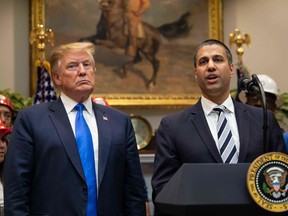 U.S. President Donald Trump, left, listens to Federal Communications Commission Chairman Ajit Pai speak during an announcement at the White House in Washington, D.C., in 2019.