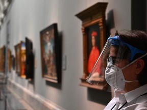 A museum worker wearing a face mask and shield stands at the Prado Museum on June 4, 2020 in Madrid, amid the coronavirus disease (COVID-19) outbreak.