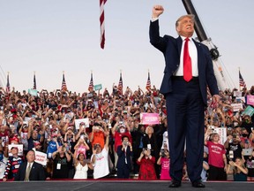 TOPSHOT - US President Donald Trump arrives to hold a Make America Great Again rally as he campaigns at Orlando Sanford International Airport in Sanford, Florida, October 12, 2020. (Photo by SAUL LOEB / AFP) (Photo by )