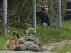A police sniper and his dog hems in convicted killer Peter Madsen, who  threatened to detonate a bomb while attempting to break out of jail in Albertslund, Denmark on 20 October 2020.