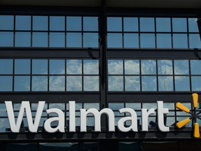 In this file photo taken on August 18, 2020 A Walmart logo is seen outside a store in Washington, DC. Walmart plans to remove guns and ammunition from its sales floors in the US following unrest in Philadelphia this week, a spokeswoman said on October 29.