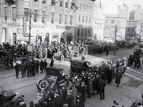 Armistice Day crowds wear masks for protection against the Flu epidemic in 1919.