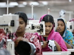 Workers sew shoes in Dhaka, Bangladesh, in 2012.