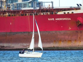 A sailboat passes in front of the Liberia-flagged oil tanker Nave Andromeda at Southampton Docks, following a security incident aboard the ship the night before off the coast of Isle of Wight, in Southampton, Britain, October 26, 2020.