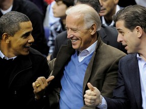 Joe Biden, centre, and his son Hunter attend an NCAA basketball game between Georgetown University and Duke University with then-president Barack Obama in Washington in a file photo from Jan. 30, 2010.