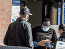 People outside a COVID-19 assessment centre at Toronto Western Hospital, Wednesday October 28, 2020.