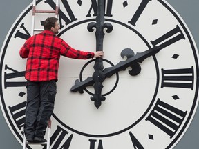 Picture taken on March 23, 2018 shows a technician working on the clock of the Lukaskirche Church in Dresden, eastern Germany. (Photo by Sebastian Kahnert / dpa / AFP) / Germany OUT