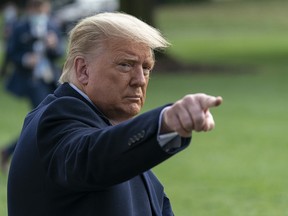 U.S. President Donald Trump gestures to the press while walking on the South Lawn of the White House before boarding Marine One in Washington, D.C., on Oct. 30, 2020.