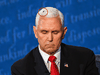 A housefly rests on the head of U.S. Vice President Mike Pence as he takes notes during the vice presidential debate against Democratic vice presidential nominee Kamala Harris on October 7, 2020.