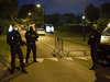 French police officers stand guard a street in Eragny on October 16, 2020, where an attacker was shot dead by policemen after he decapitated a man earlier on the same day in Conflans-Sainte-Honorine.