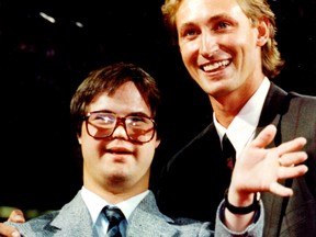 Joey Moss, locker room attendant for the Edmonton Oilers and the Edmonton Eskimos, poses for a photo with long-time friend Wayne Gretzky in a file photo from Aug. 27, 1989.