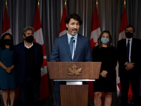 Prime Minister Justin Trudeau, centre, flanked by some of his cabinet ministers, speaks to media following a cabinet retreat in Ottawa, on Sept. 16.