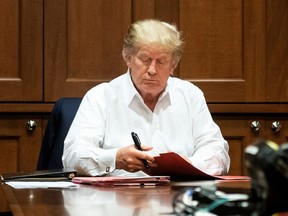 U.S. President Donald Trump works in a conference room while receiving treatment after testing positive for COVID-19 at Walter Reed National Military Medical Center in Bethesda, Maryland, U.S. October 3, 2020.