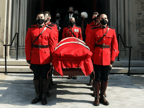 RCMP pallbearers carry out the flag-draped coffin of the late former Prime Minister John Turner during his state funeral at St. Michael's Cathedral Basilica in Toronto, October 6, 2020.