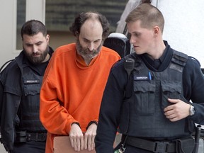 Matthew Vincent Raymond is escorted from provincial court in Fredericton on Friday, Feb. 8, 2019.