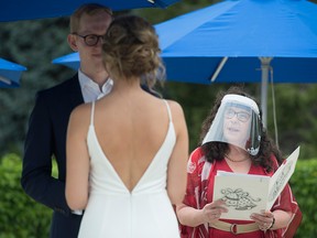 Wedding Commissioner Ruth Lipton, wearing a protective face shield, marries Nikki Alexis and Roni Jones during a city of Vancouver micro-wedding pilot project outside of Vancouver City Hall on June 19, 2020. Author Lauren Heuser urges Ontario municipalities to do more to help couples tie the knot during the coronavirus pandemic.