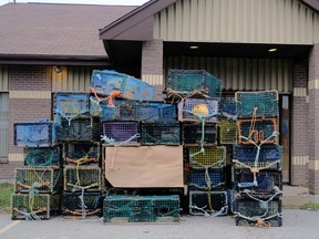 Lobster traps belonging to fishermen of the Sipekne'katik band are seen dumped at the DFO office in Meteghan. PHOTO BY TED PRITCHARD/REUTERS