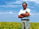 Saskatchewan farmer Percy Schmeiser stands in his field of herbicide resistant canola in 1999. Schmeiser was in a legal battle with Monsanto over his possession of the seed and crop, which Monsanto claimed was illegal to own.