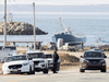 RCMP officers monitor the entrance to Saulnierville Harbour while in the background another checkpoint is being maintained, as non-Indigenous commercial fishermen protest against a Mi’kmaq lobster fishery in Nova Scotia, October 19, 2020.