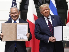 U.S. President Donald Trump and Benjamin Netanyahu, Israel's prime minister, left, hold signed documents during an Abraham Accords signing ceremony event on the South Lawn of the White House in Washington, D.C., U.S., on Tuesday, Sept. 15, 2020. PHOTO BY YURI GRIPAS/ABACA/BLOOMBERG.