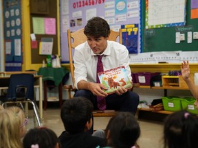 Prime Minister Justin Trudeau reads to Grade 1 and 2 pupils at Blessed Sacrament Catholic elementary school in London, Ont., in a file photo from Sept. 16, 2019.