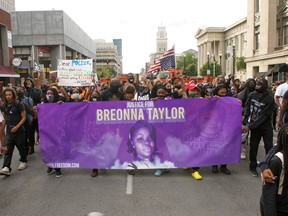 Protesters march through downtown Louisville after a grand jury decided not to bring homicide charges against police officers involved in the fatal shooting of Breonna Taylor, in Louisville, Kentucky September 25, 2020.