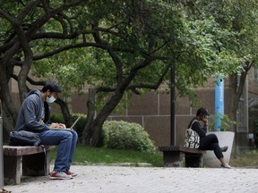 People sit at the Ryerson University campus in Toronto, Tuesday, Sept. 8, 2020. Post-secondary students are paying the same or more tuition compared to last year, including fees for inaccessible facilities as many take classes online.