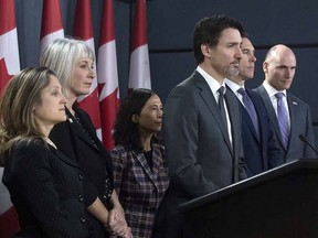 Prime Minister Justin Trudeau listens to a question with Deputy Prime Minister and Minister of Intergovernmental Affairs Chrystia Freeland, Minister of Health Patty Hajdu, Chief Medical Officer Theresa Tam, Minister of Finance Bill Morneau and President of the Treasury Board Jean-Yves Duclos during a news conference on the coronavirus situation, in Ottawa on Wednesday, March 11.
