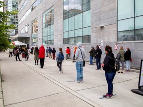 People wait in line at the Women's College coronavirus disease (COVID-19) testing facility in Toronto, Ontario, September 18, 2020.