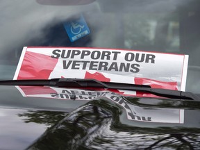 A sign is placed on a truck windshield as members of the advocacy group Banished Veterans protest outside the Veterans Affairs office in Halifax on June 16, 2016.