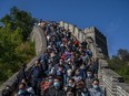 hinese tourists crowd in a bottleneck as they move slowly on a section of the Great Wall at Badaling after tickets sold out during the 'Golden Week' holiday on October 4, 2020  in Beijing, China.