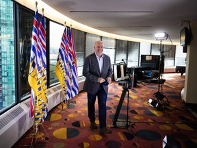 B.C. Premier John Horgan smiles as he leaves after a post-election news conference in Vancouver on Sunday, Oct. 25, 2020.