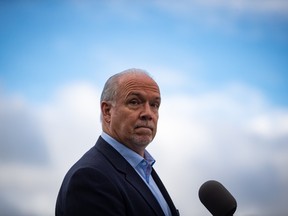 NDP Leader John Horgan pauses while responding to questions during a campaign stop, in Vancouver, on Monday, October 12, 2020. A provincial election will be held in British Columbia on October 24.