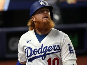 Justin Turner #10 of the Los Angeles Dodgers reacts after striking out against the Tampa Bay Rays during the first inning in Game Six of the 2020 MLB World Series at Globe Life Field on October 27, 2020 in Arlington, Texas.