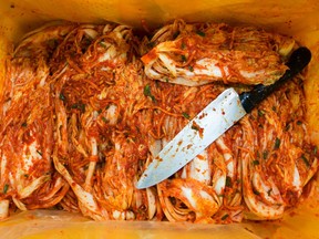 Seasoned kimchi and a knife sit inside a crate on the production line at the Ogawon Co. organic kimchi factory in Yangpyeong, South Korea, on Wednesday, Sept. 2, 2015.