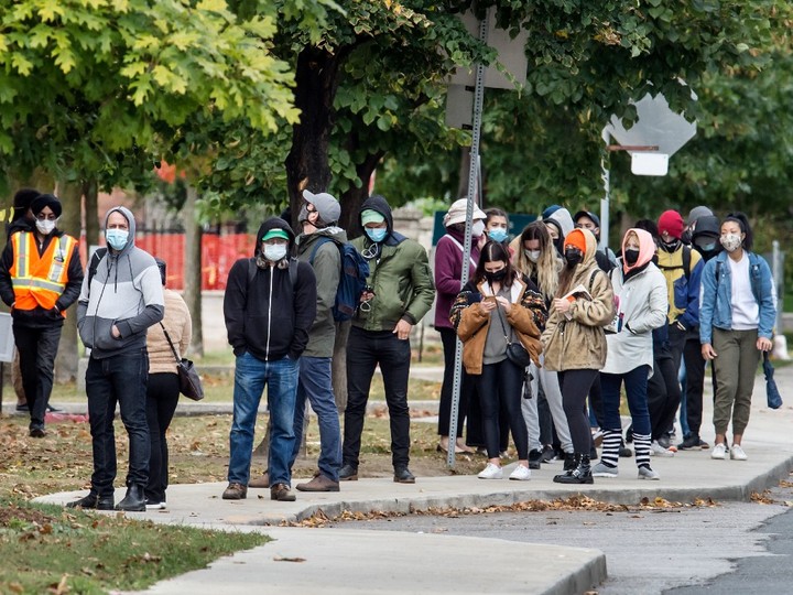  People wearing masks wait in line for Covid 19 Testing at Toronto’s St. Joseph’s Health Centre during the Covid 19 Pandemic, Friday October 2, 2020.