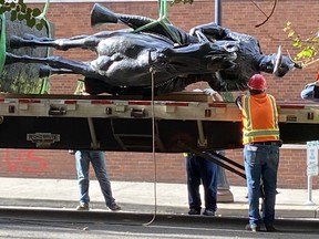 Workers prepare to cart away a statue of U.S. President Theodore Roosevelt after “Indigenous rage” protesters pulled it down from its perch in a Portland, Ore., park the night before. Despite the city’s heavily white population, it has become the epicentre of America’s anti-racism movement, and a focus of President Donald Trump’s re-election campaign.
